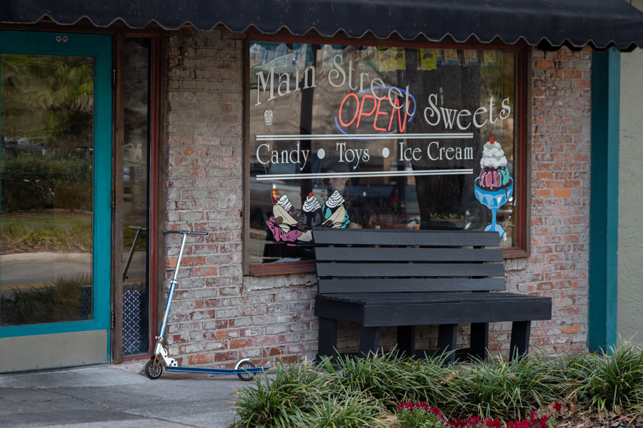 Photograph of Main Street Sweets restaurant in downtown Alachua with a scooter by the door. Alachua, FL; March 10, 2020. 