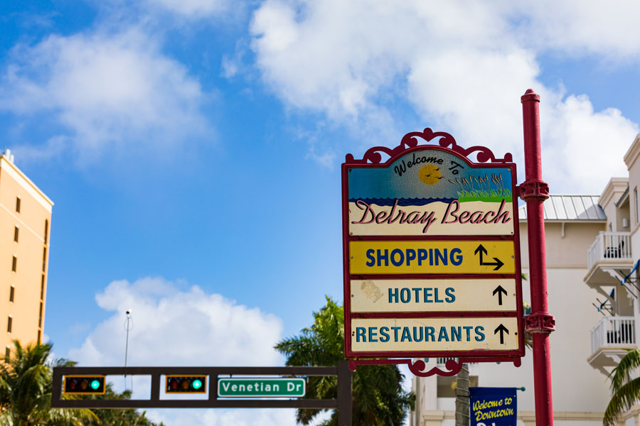 Delray Beach welcome sign on the popular Atlantic Avenue offers directions and arrows. 