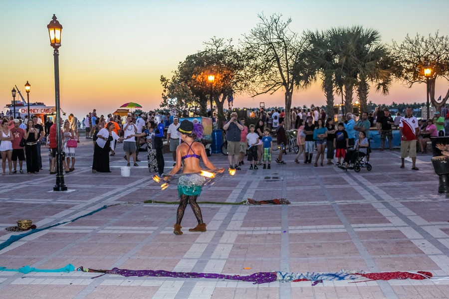 A fire eater walking on hot coals during the Sunset Celebration at Mallory Square. Shows of street artists is one of most popular attractions of Key West. Key West, Florida, April 12, 2012.