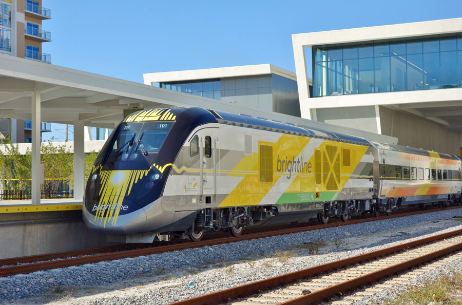 View of the Brightline train, a diesel–electric higher-speed rail system, at the West Palm Beach rail station in West Palm Beach, Florida.  Brightline has stations at Miami, Fort Lauderdale and West Palm. March 2018. Editorial credit: EQRoy / Shutterstock.com, licensed.