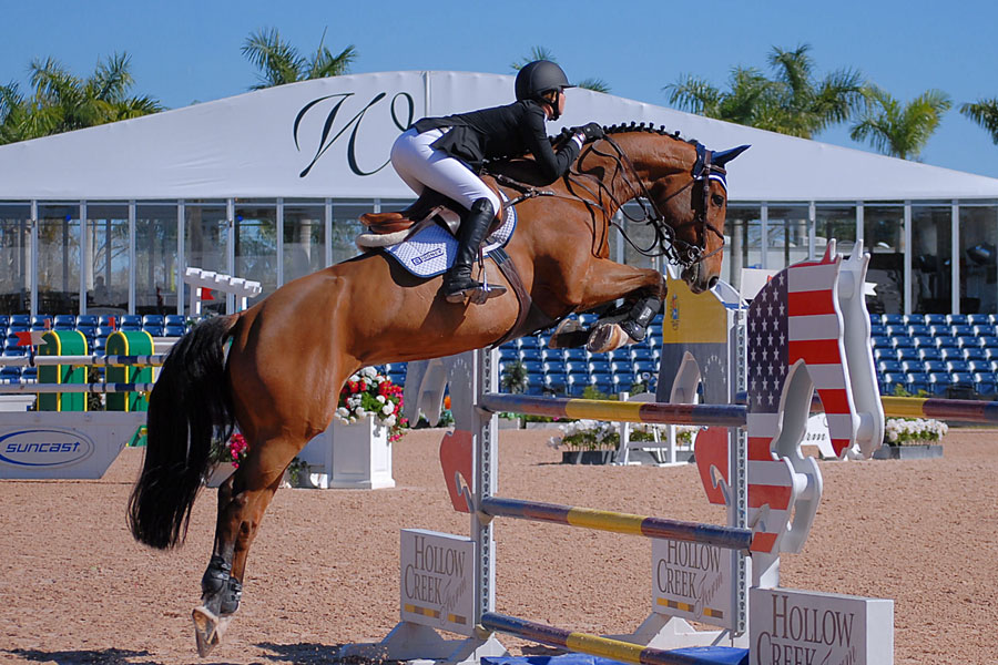 Kaely Tomen and Boriena H compete to finish in the Medium Junior Jumper class during week 2 of the FTI Consulting Winter Equestrian Festival. Editorial credit: Perry Correll / Shutterstock.com, licensed.