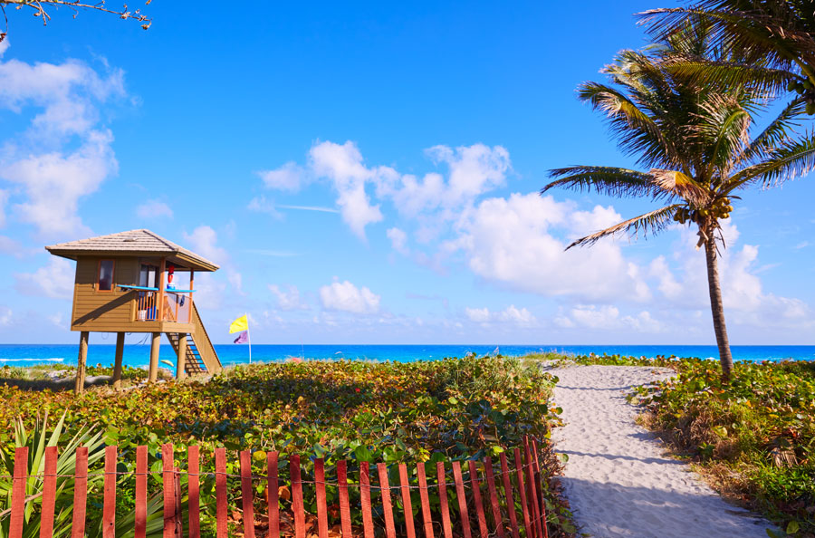 Tropical blue green waters off a Delray beach near a swimmers watchtower. Photo credit ShutterStock.com, licensed.