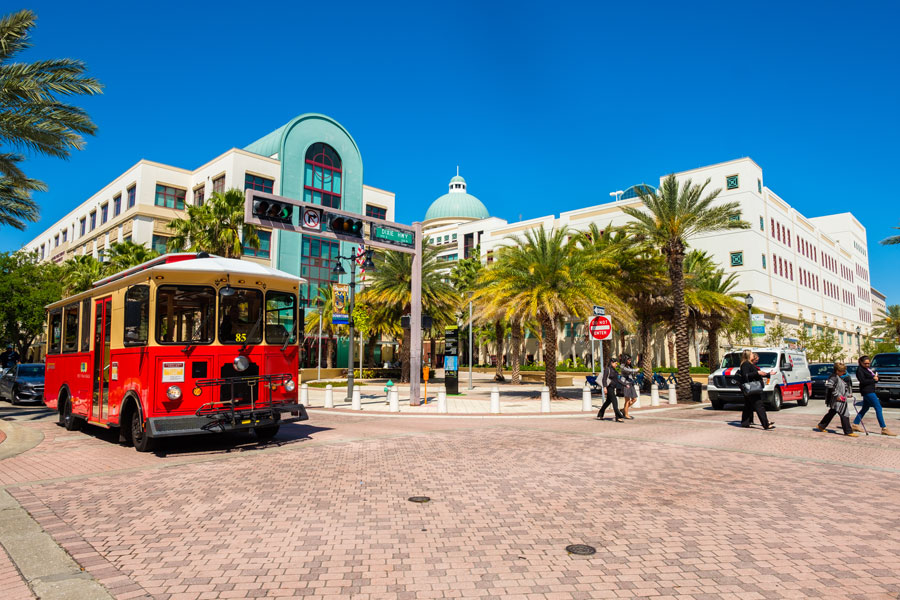 Cityscape view of the the popular West Palm Beach downtown district with City Hall along Clematis Street. West Palm Beach, Florida - March 14, 2018. Editorial credit: Fotoluminate LLC / Shutterstock.com, licensed.