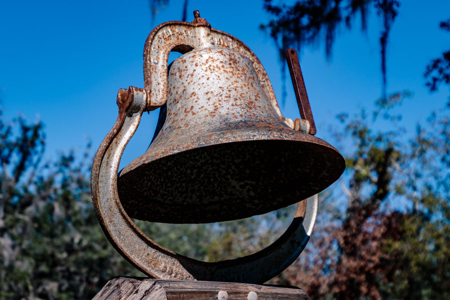 An old metal rusty bell in the park area of Arcadia Peace River Campground, Arcadia, FL. Photo credit ShutterStock.com, licensed.