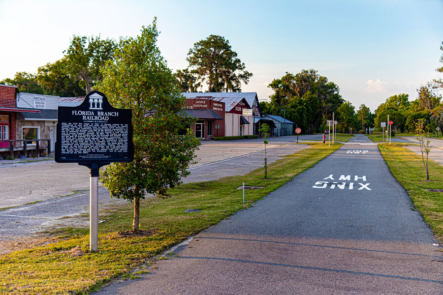 A sign marks the site and history of the former Florida Branch Railroad on which this walking and cycling trail is built. Jasper, Florida, 