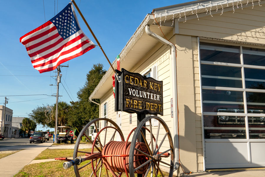 Volunteer Fire Department with American flag and firetruck parked in garage in downtown Cedar Key, Florida. 