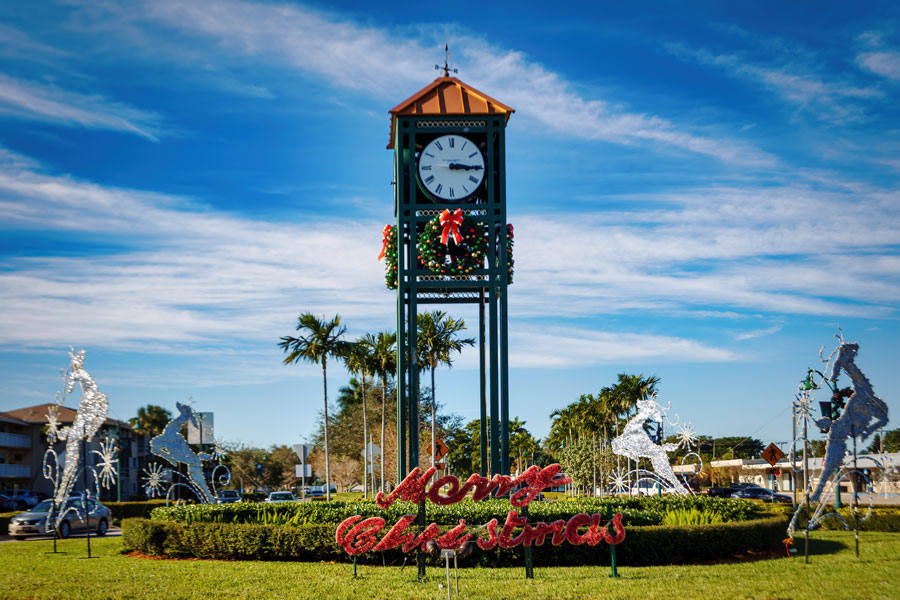 The city clocktower decorated festively for the holidays with a Merry Christmas sign in front on January 01, 2021. 