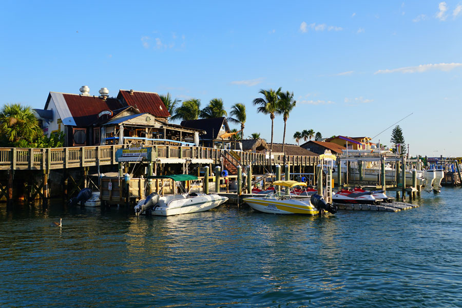 The restaurants and boats on the dock by John's Pass Boardwalk and the canal in Madeira Beach, Florida on September 29, 2019.