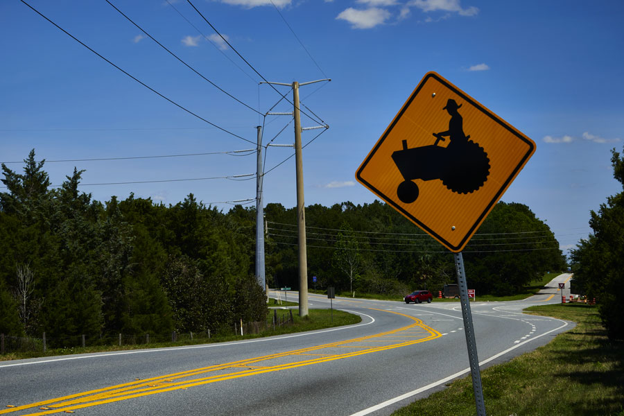 A sign indicating farm equipment highway crossing in Leesburg, Florida in March 2020. 