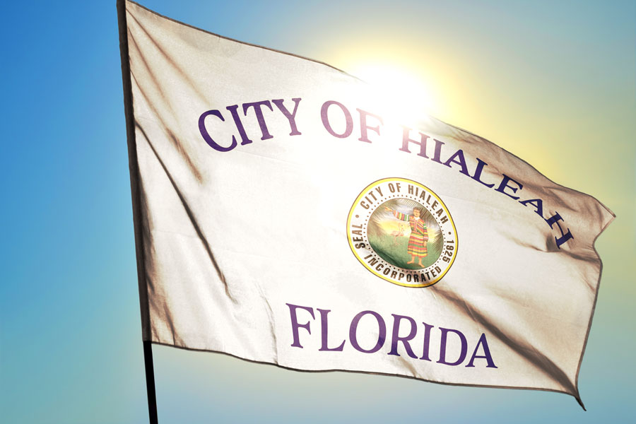 A City of Hialeah Florida flag waving on the wind in front of the sun. Photo credit ShutterStock.com, licensed.