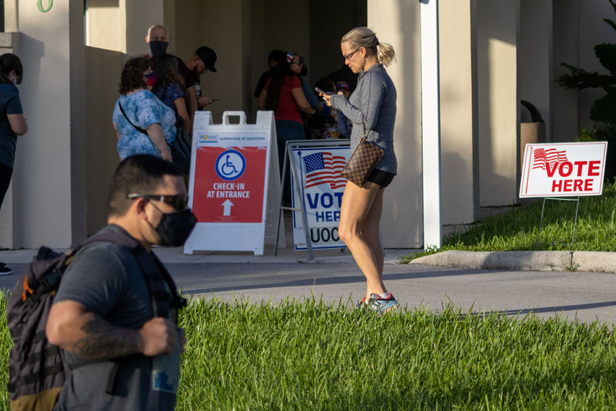 People waiting in line to vote at city hall in Cooper City, Florida on November 3, 2020