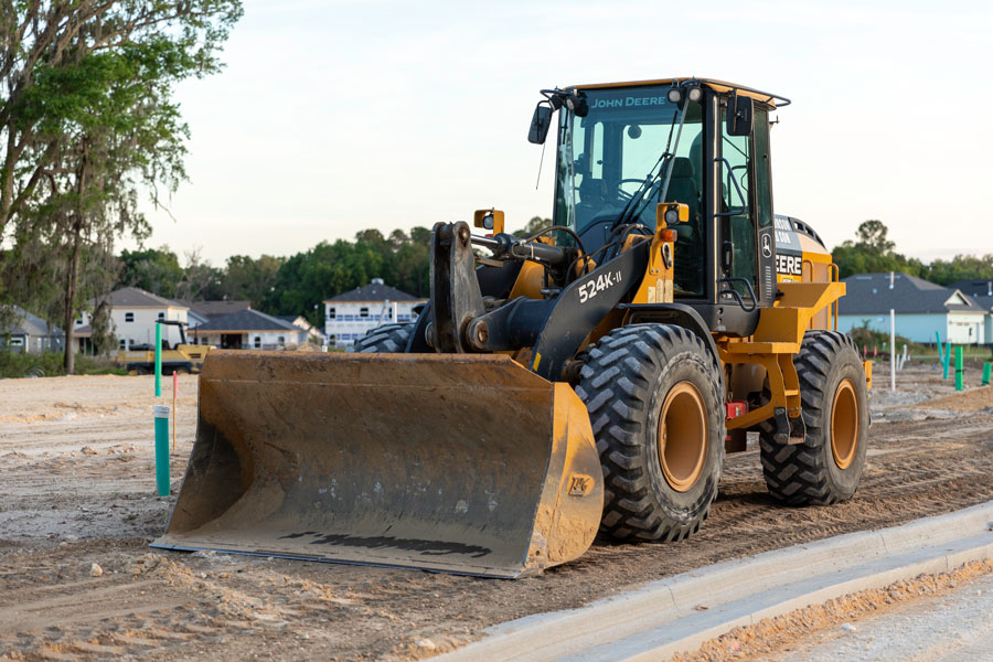 A road construction front loader parked in the Arbor Greens subdivision off Newberry Road where new housing construction will begin once the road has been completed. 