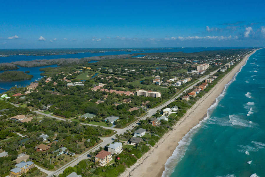 An Aerial View of property and on the barrier island in Brevard County Florida with the Indian River Lagoon at far left. 