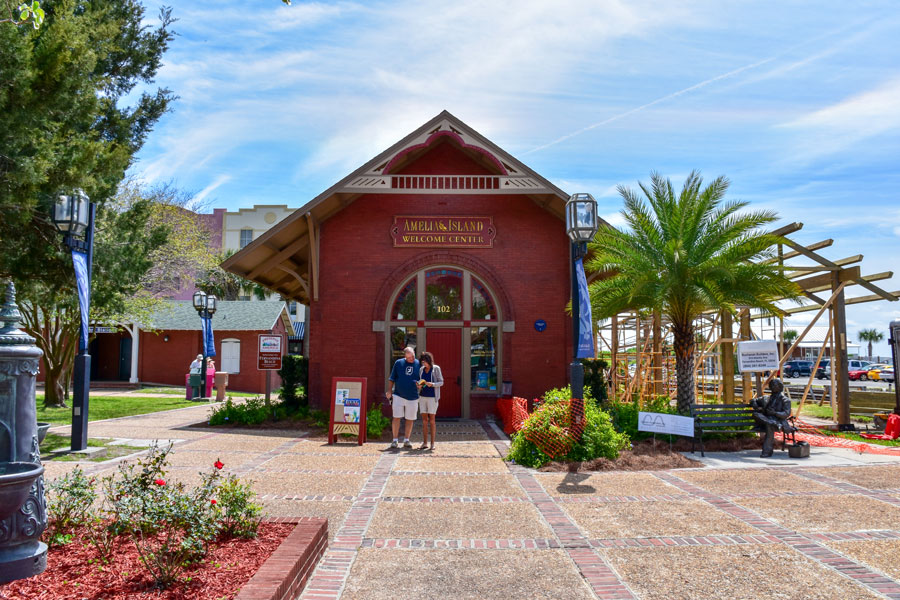 A couple standing in front of the Welcome Center at Amelia Island, Florida, set off to explore the town. Editorial credit: Joanne Dale / Shutterstock.com, licensed.