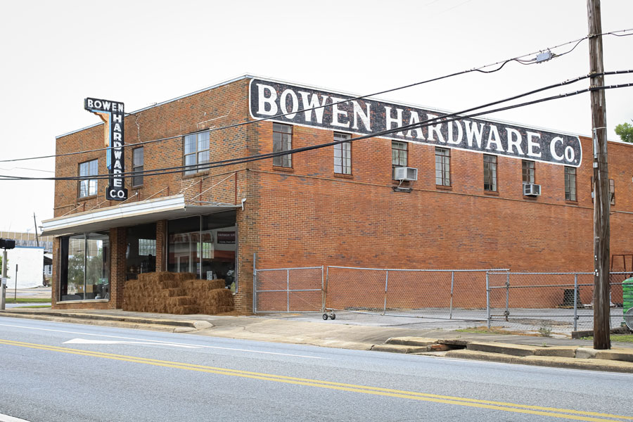 A historic building with a pile of hay bales near the entrance. Bonifay, Florida