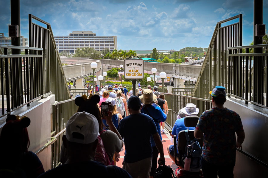 People walking into the Magic Kingdom park at Disney World from the monorail station