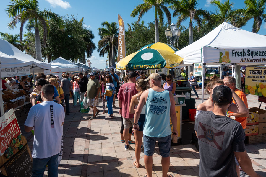 People shopping at the farmer's market at Fort Pierce Florida on a sunny Saturday morning.Fort Pierce, Florida on April 20, 2019. 