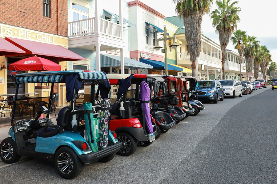 Golf carts parked side by side at a local restaurant in downtown Sumter Landing. The Villages is a popular retirement golf cart loving community as seen on October 25, 2020. 