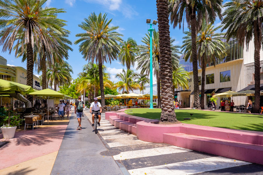 The beautiful Lincoln Road Mall in Miami Beach is a popular international travel destination with palm trees and art deco architecture.